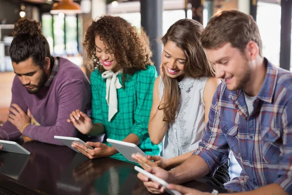 Friends using digital tablet in restaurant — Stock Photo, Image