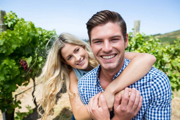 Cheerful couple embracing at vineyard — Stock Photo, Image