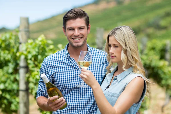 Couple holding wine bottle and glass — Stock Photo, Image