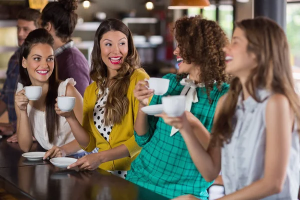Друзі говорять під час пиття кави в кафе — стокове фото
