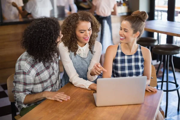 Cheerful friends using laptop — Stock Photo, Image