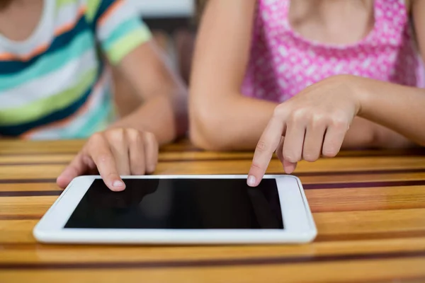 Siblings using digital tablet in kitchen — Stock Photo, Image