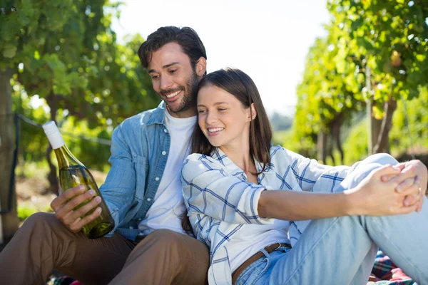 Feliz casal segurando garrafa de vinho — Fotografia de Stock