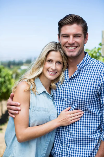 Happy couple embracing at vineyard — Stock Photo, Image