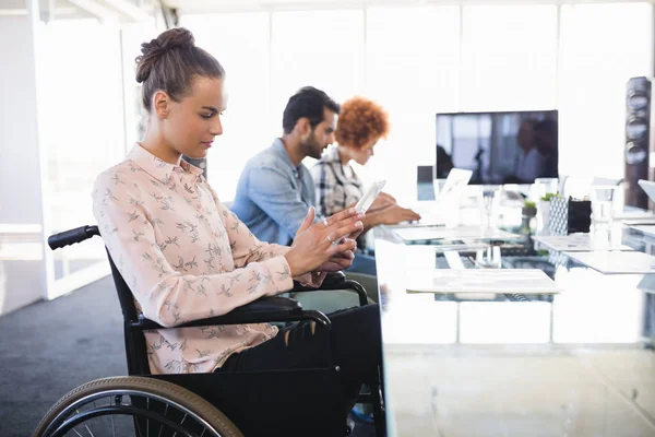 Businesswoman using tablet on wheelchair — Stock Photo, Image
