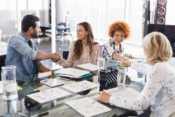 Business people shaking hands at creative office — Stock Photo, Image