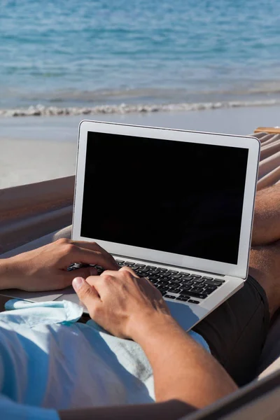 Man met laptop op hangmat — Stockfoto