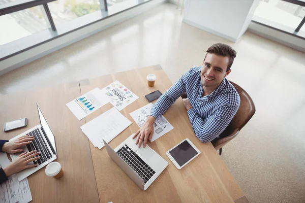 Smiling executive working at desk — Stock Photo, Image