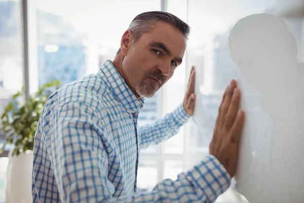 Sad executive leaning on wall — Stock Photo, Image