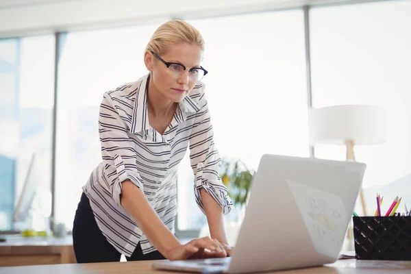 Attentive executive using laptop at desk — Stock Photo, Image