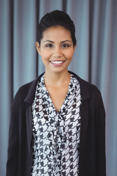 Smiling executive standing in office — Stock Photo, Image