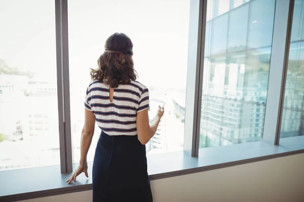 Thoughtful executive standing near window — Stock Photo, Image