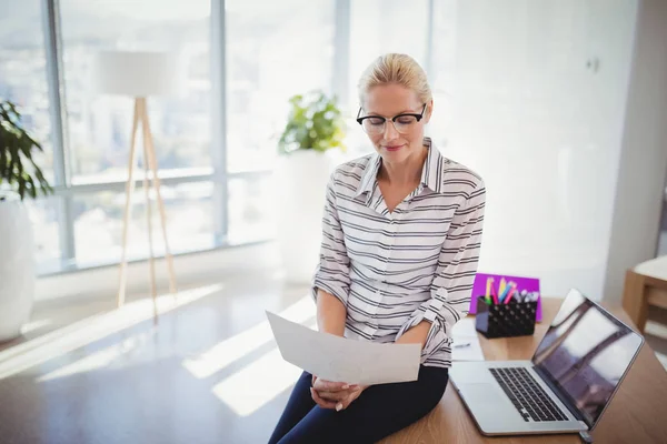 Attentive executive reading document at desk — Stock Photo, Image