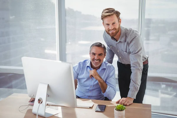 Smiling executives at desk — Stock Photo, Image