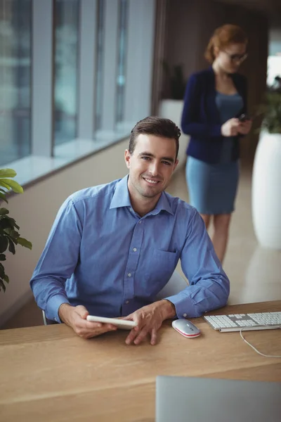 Executive using digital tablet at desk — Stock Photo, Image