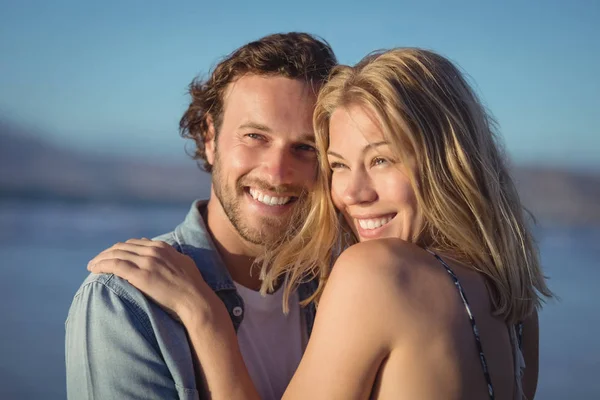 Thoughtful couple hugging at beach — Stock Photo, Image