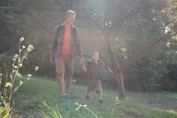 Glücklicher Vater und Sohn wandern im Gras — Stockfoto