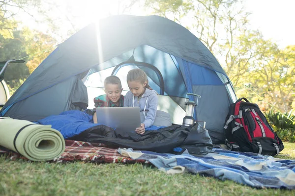 Enfants utilisant un ordinateur portable dans la tente — Photo