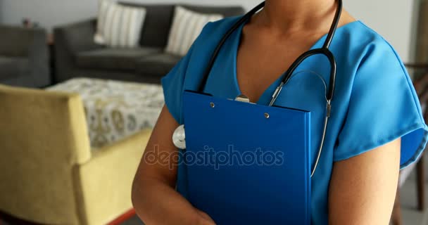 Portrait of female doctor holding a clipboard — Stock Video