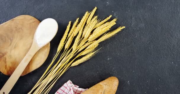 Baguette wrapped in napkin and wheat grains — Stock Video