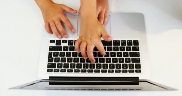 Siblings using laptop at home — Stock Video