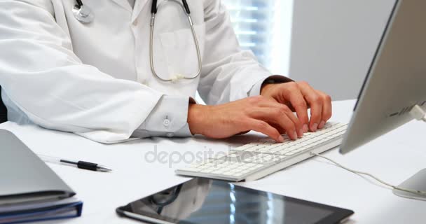 Mid-section of doctor typing on keyboard — Stock Video