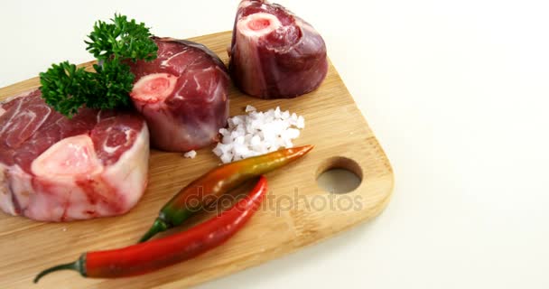 Raw meat and ingredients on wooden board — Stock Video
