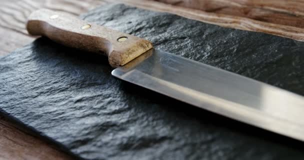 Kitchen knife on stone board — Stock Video