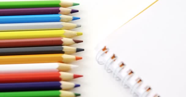 Sarmal kitap ile renkli kalemler — Stok video