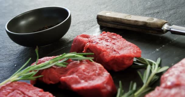 Raw meat and rosemary on the board — Stock Video