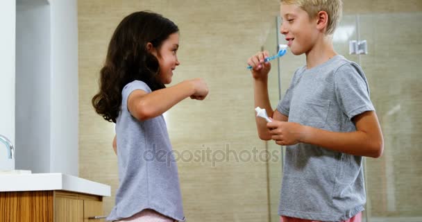 Hermanos cepillándose los dientes en el baño — Vídeos de Stock