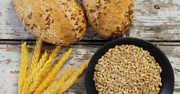 Granos de trigo con bollos de pan, avena y cuchara llena de harina — Vídeo de stock