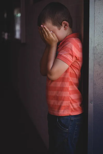 Boy covering his face with hands — Stock Photo, Image