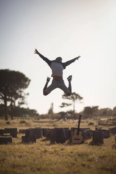 Mannen hoppar på fältet — Stockfoto
