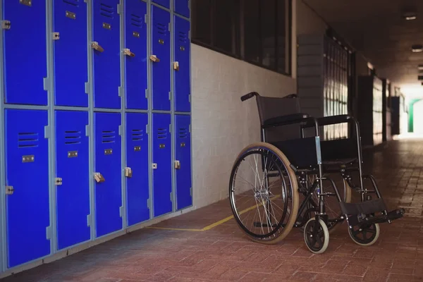 F wheel chair by lockers in corridor — Stock Photo, Image