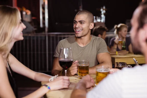 Man met vrienden zitten in nachtclub — Stockfoto