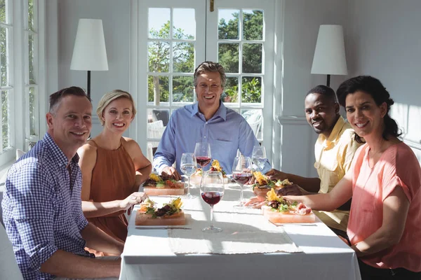 Happy friends while having meal — Stock Photo, Image