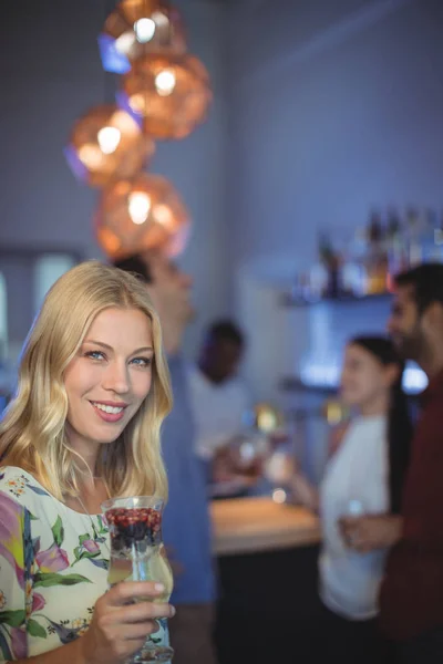 Woman holding glass of cocktail — Stock Photo, Image