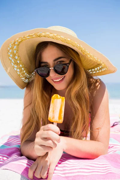 Woman holding Popsicle at beach — Stock Photo, Image