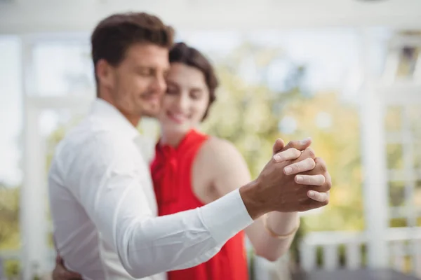 Romantic couple dancing with hand in hand — Stock Photo, Image