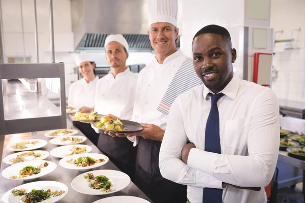 Restaurant manager with kitchen staff — Stock Photo, Image
