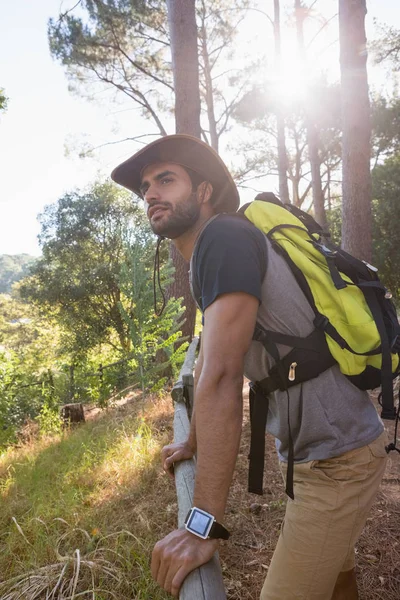 Uomo con zaino appoggiato su recinzione in legno — Foto Stock