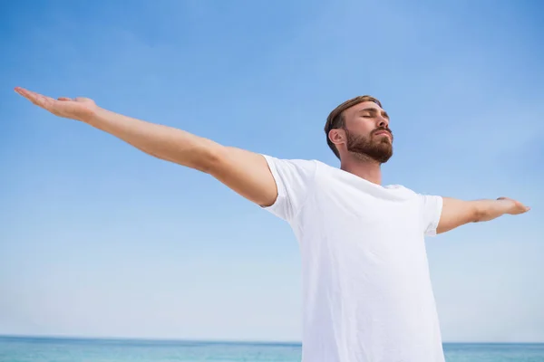 Man with arms outstretched exercising at beach — Stock Photo, Image