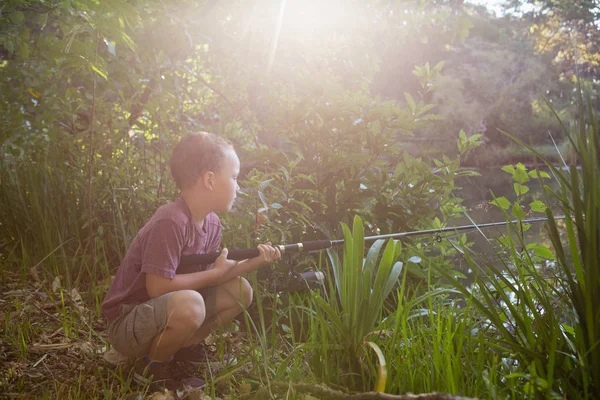 Boy fishing in the river — Stock Photo, Image