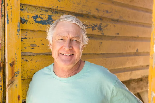 ビーチ小屋に対して立っている笑顔の男 — ストック写真