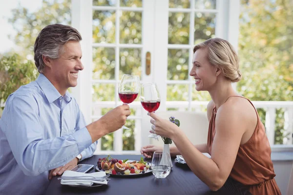 食事をしながらワイン グラスを乾杯カップル — ストック写真
