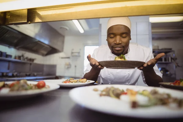 Chef oliendo comida en cocina comercial — Foto de Stock