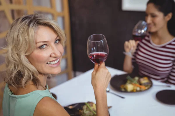 Woman having a glass of red wine — Stock Photo, Image