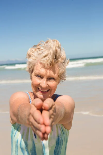 Starší žena stojící proti moři — Stock fotografie
