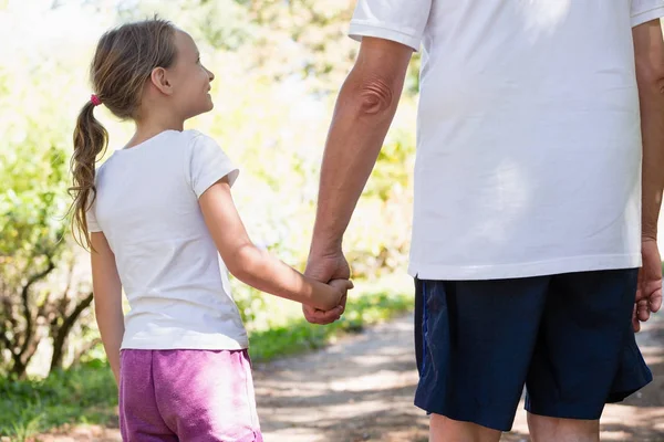 Grandfather and granddaughter holding hands — Stock Photo, Image